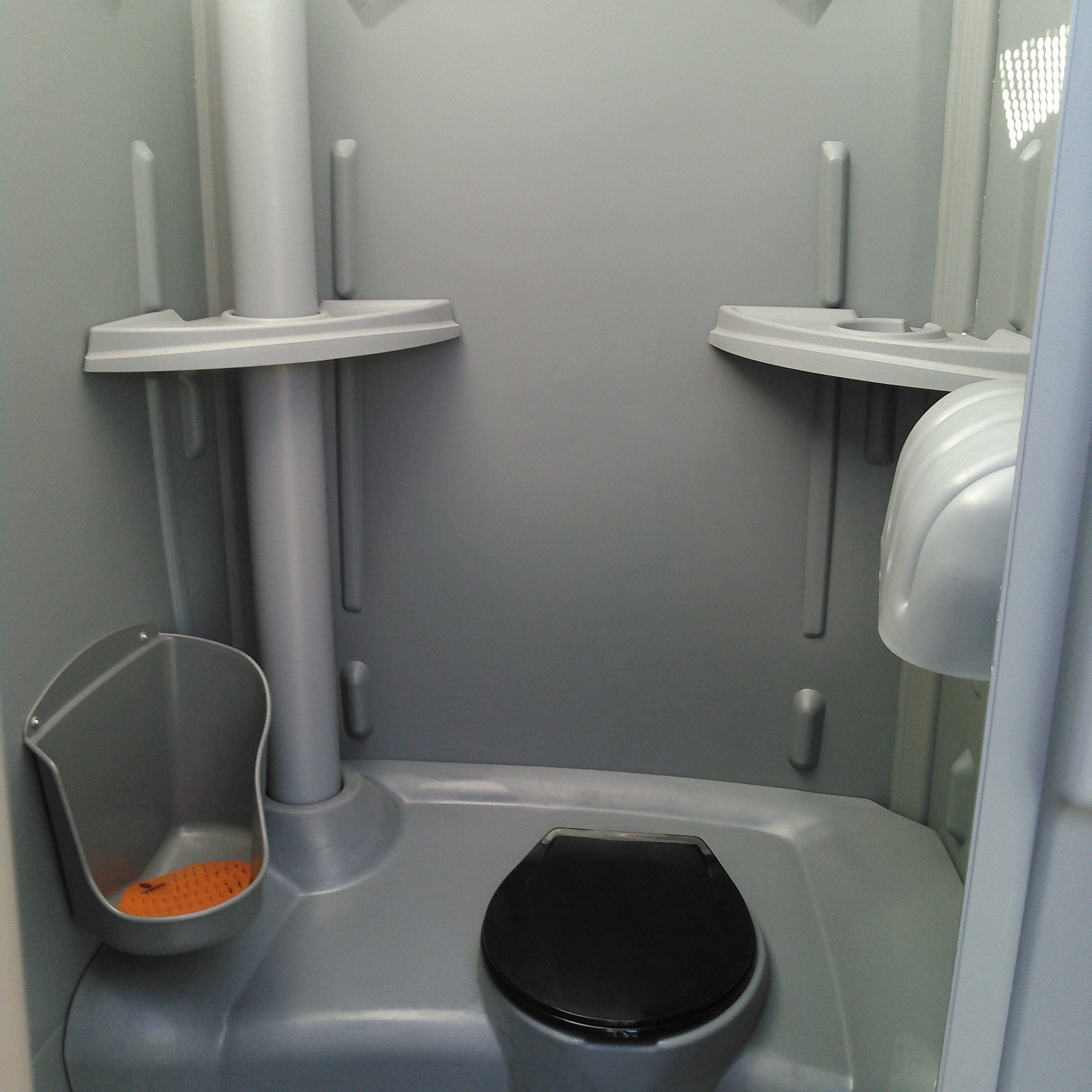 Clean, well-stocked portable toilet interior